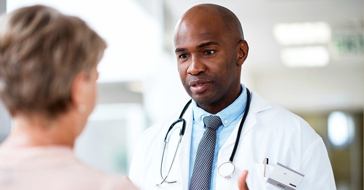 African american doctor speaking to a female patient