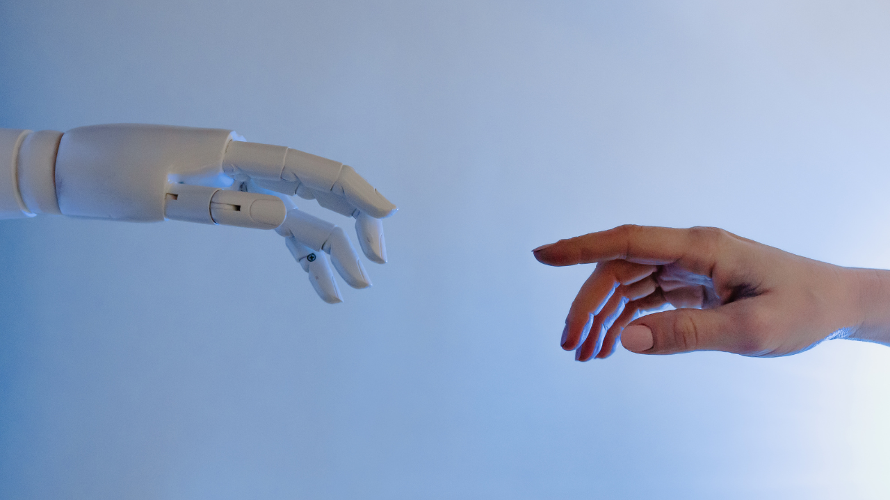 a robotic hand touching a human hand