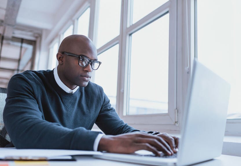 Doctor with glasses on laptop