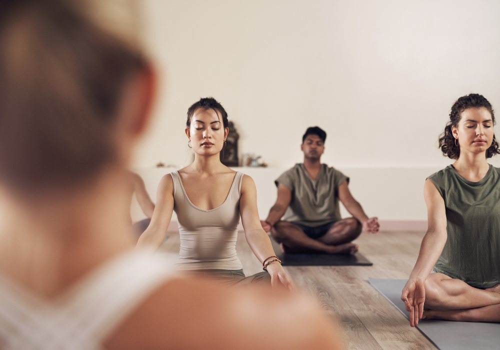 a group of diverse women and men doing yoga