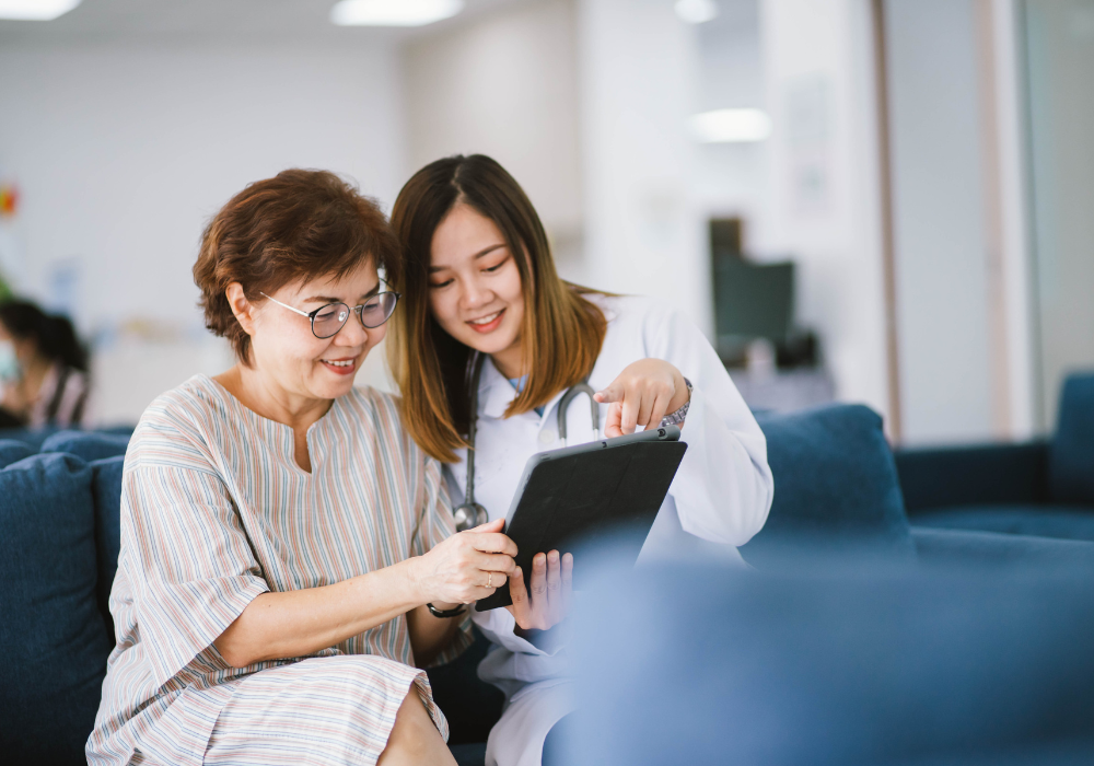 asian female doctor showing tablet to patient