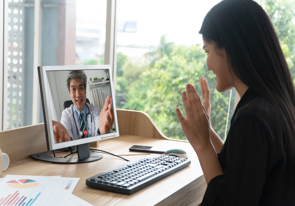 a young asian patient having a virtual appointment with a doctor