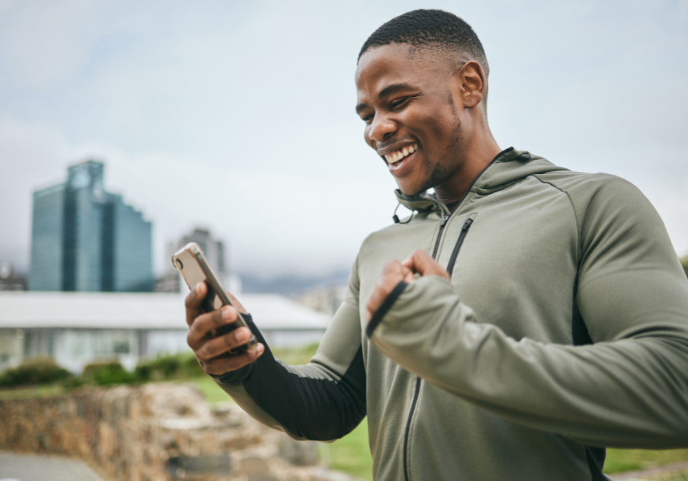 african american male smiling at phone