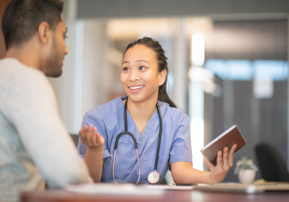 asian female nurse smiling with a male patient