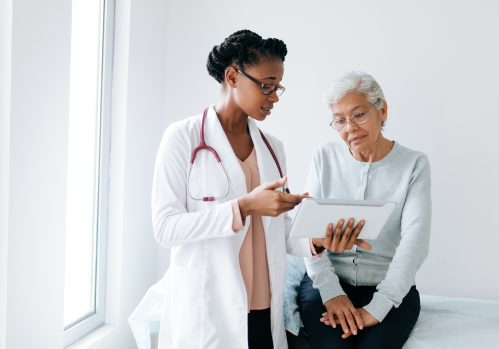 black female doctor explaining notes to elder female patient