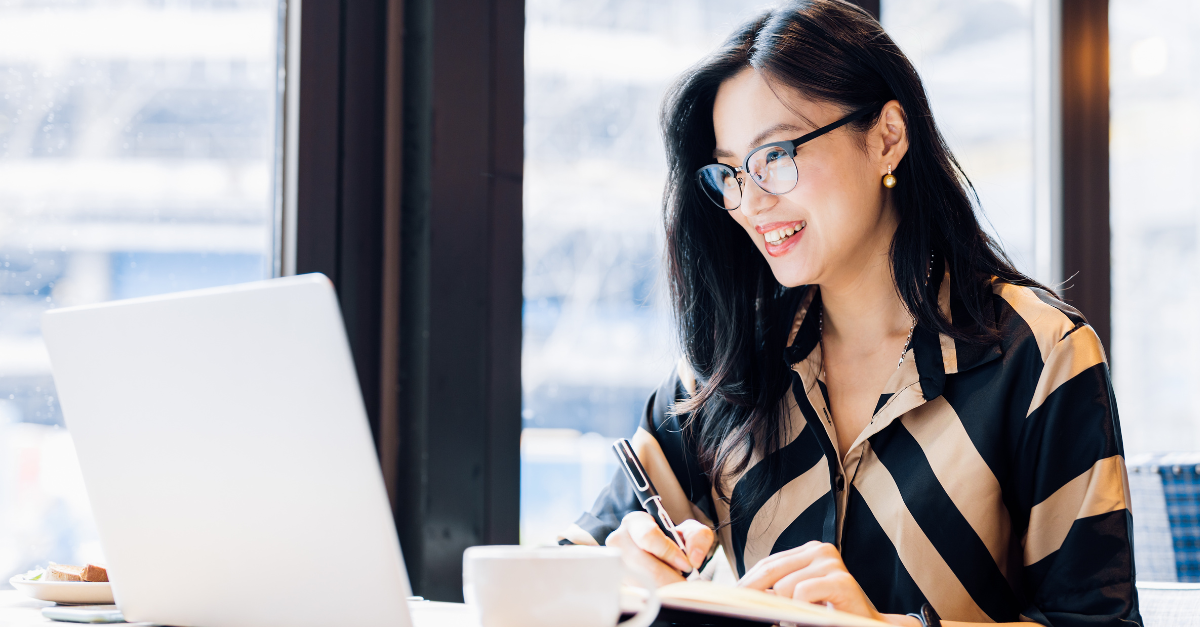 asian woman in glasses on laptop