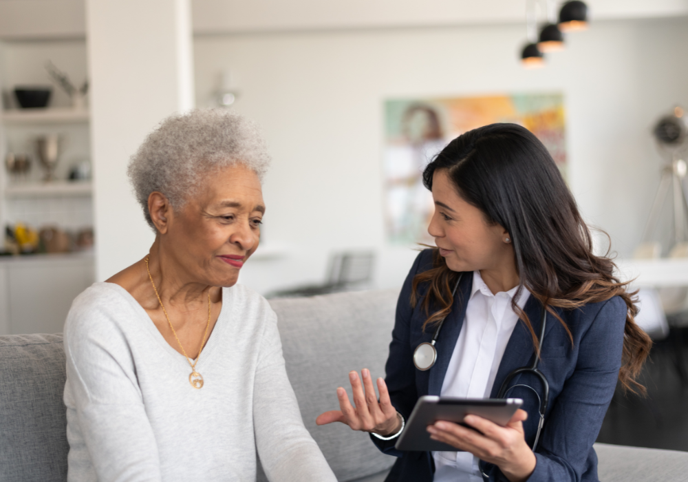 asian doctor speaking to an elder female patient