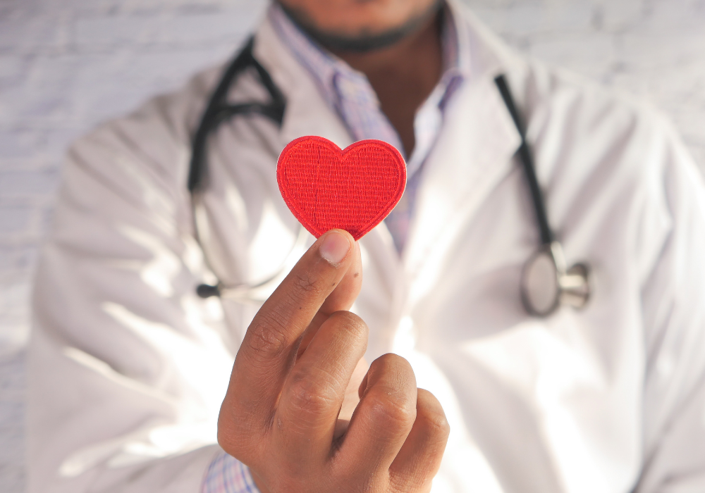 doctor holding up a red heart