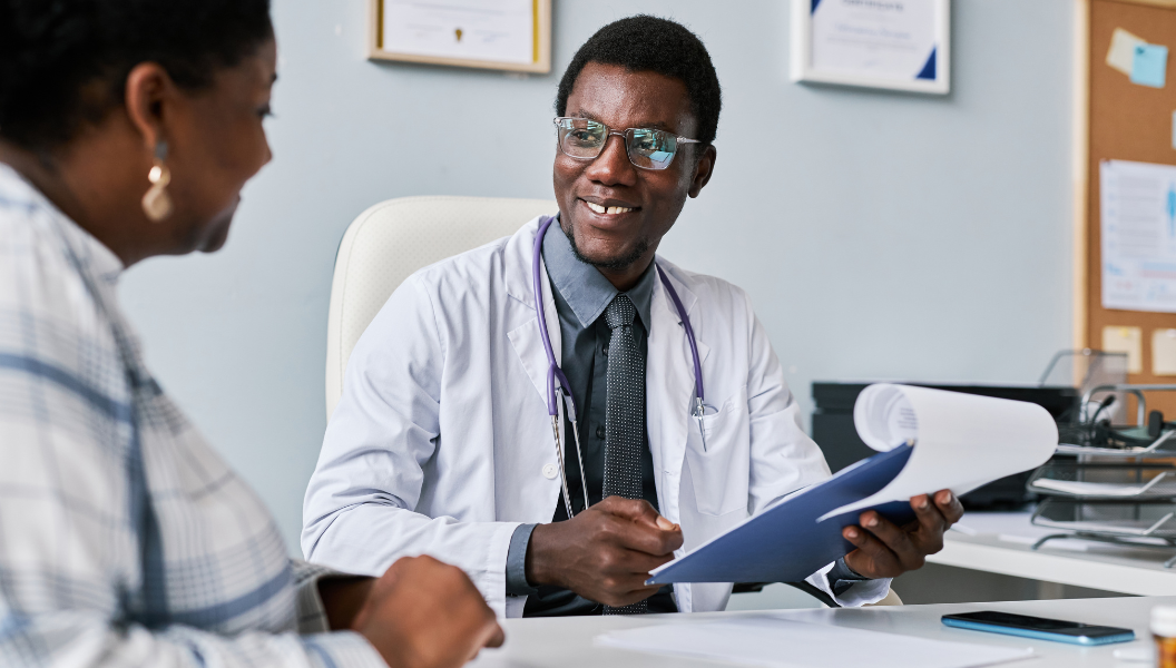 male doctor laughing with a woman and child (2)