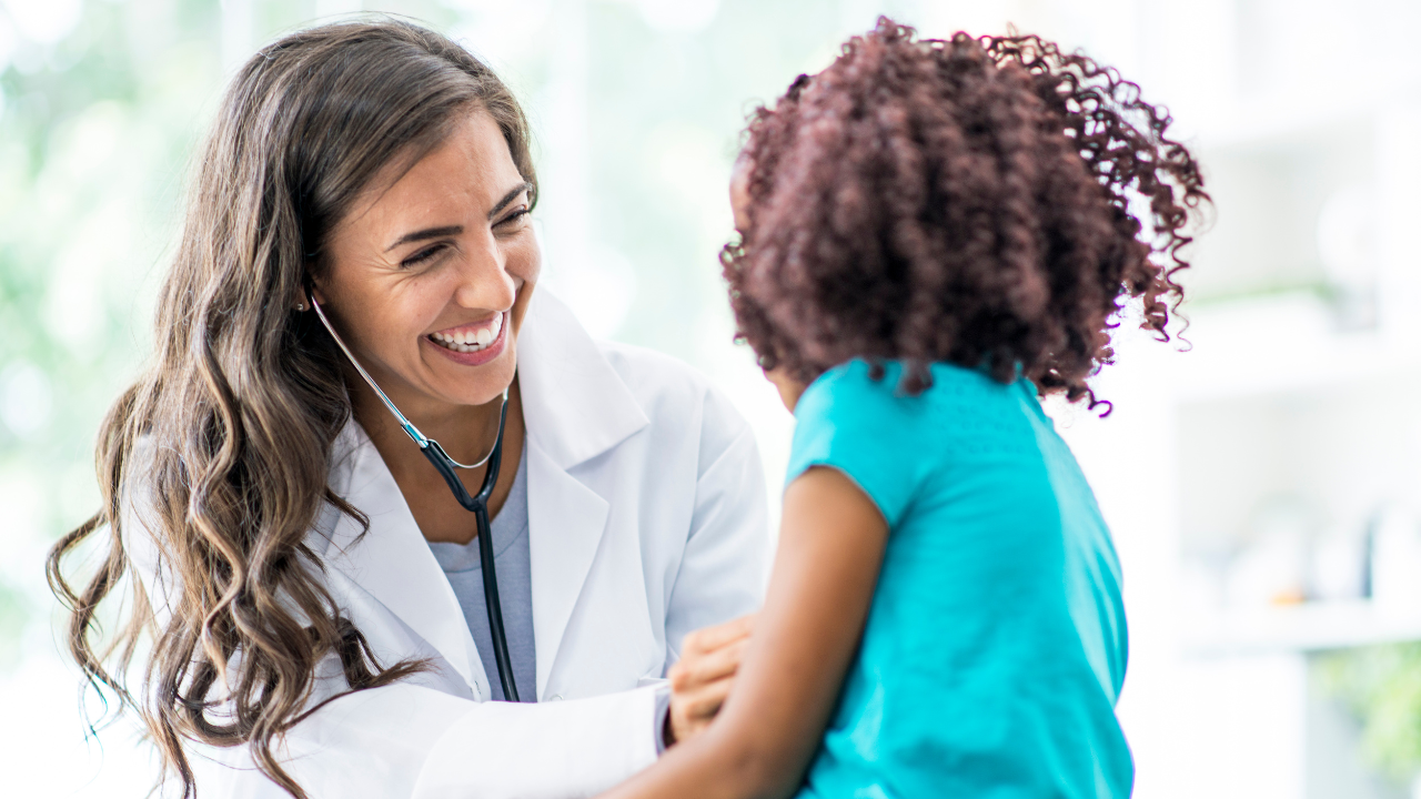 female doctor laughing with a young patient