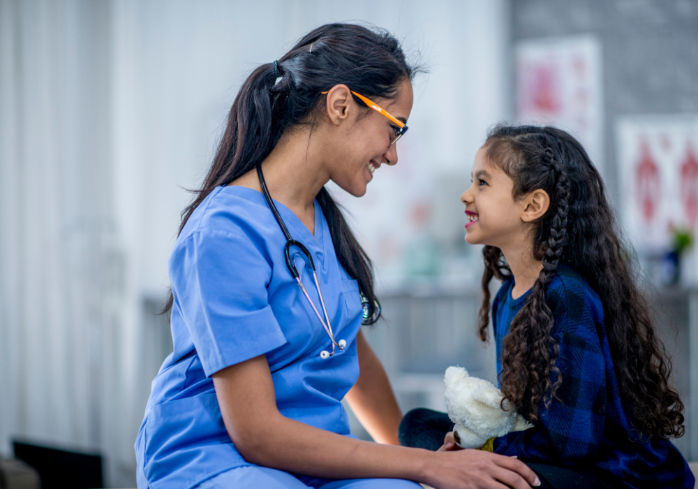 female doctor smiling with a young girl