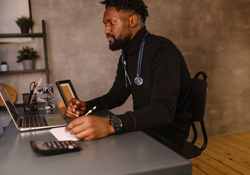 african american male doctor on a computer