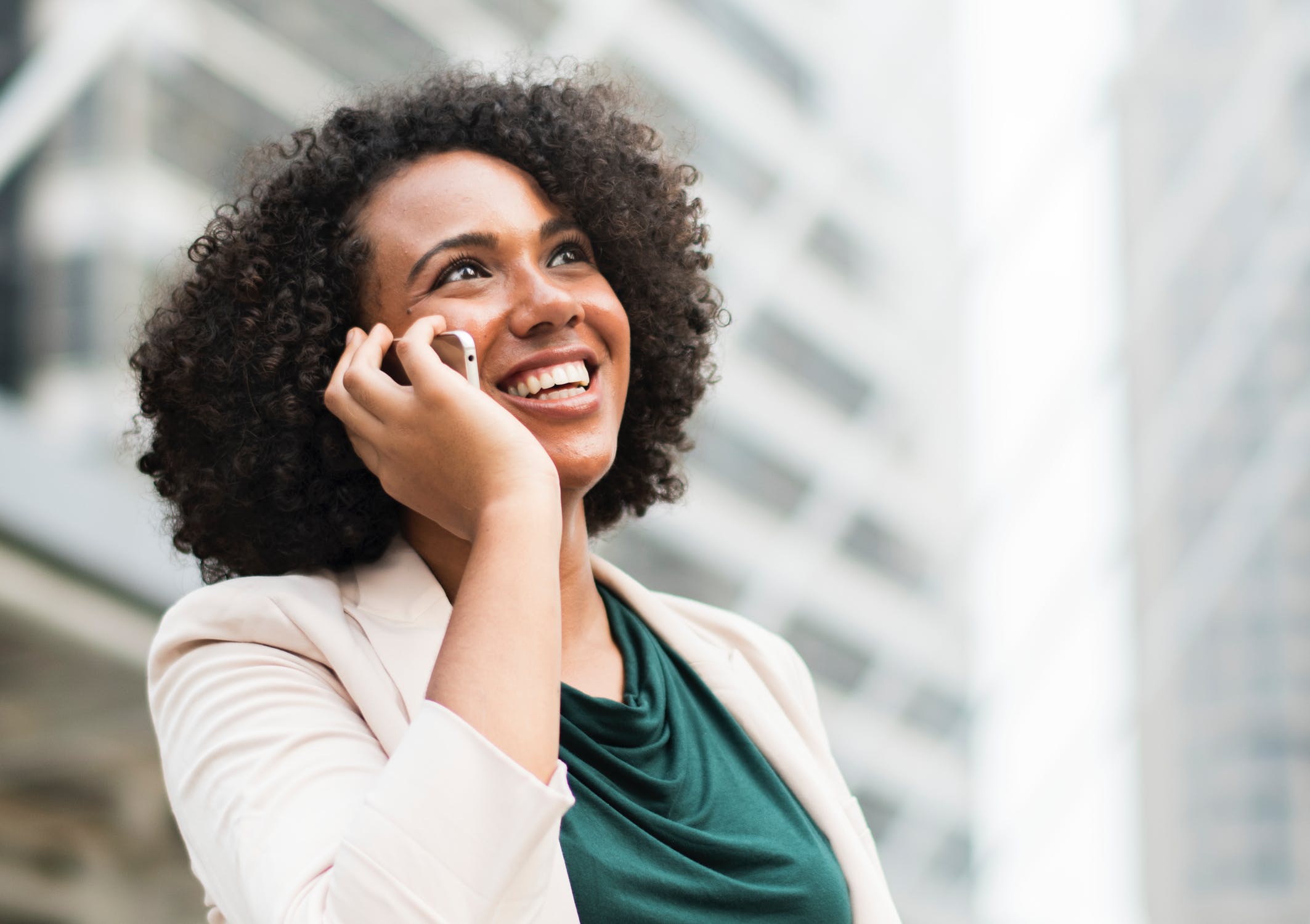 african american woman smiling on mobile phone