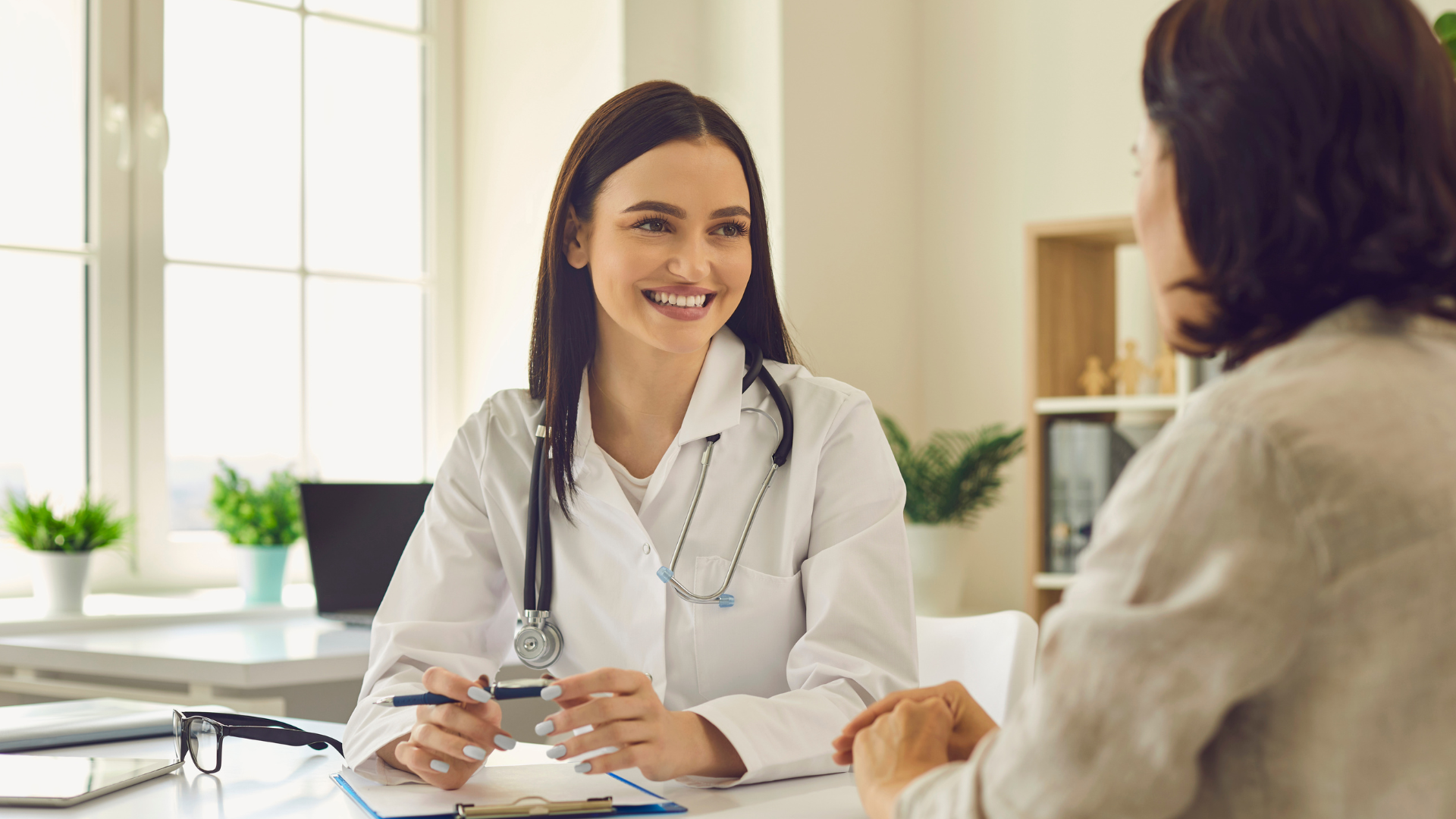 young female doctor laughing with patient