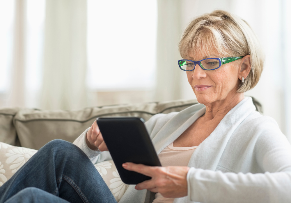 woman on tablet smiling (1)